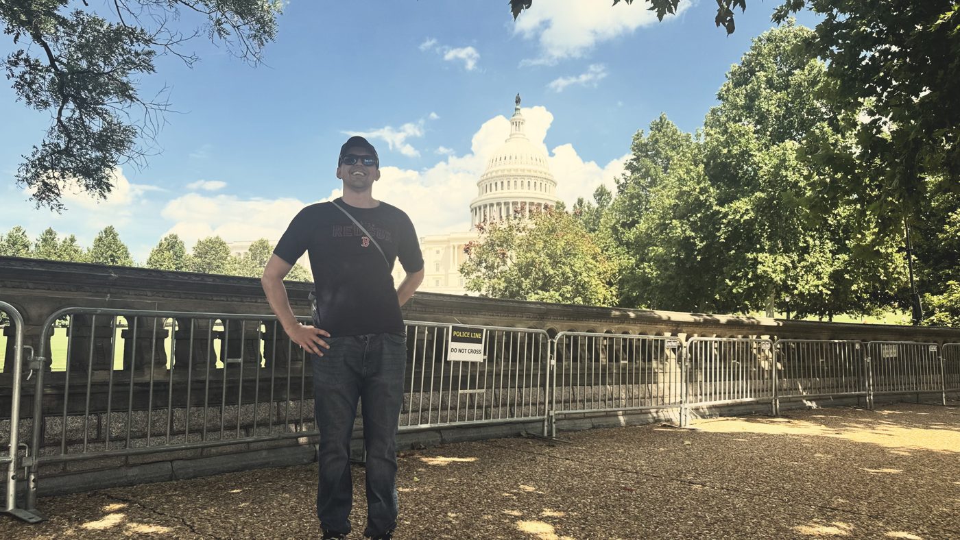 Sam Castillo standing outdoors with the U.S. Capitol behind him